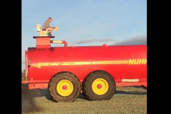 ontario-farmer-toilet-to-the-top-of-manure-spreaders-tank
